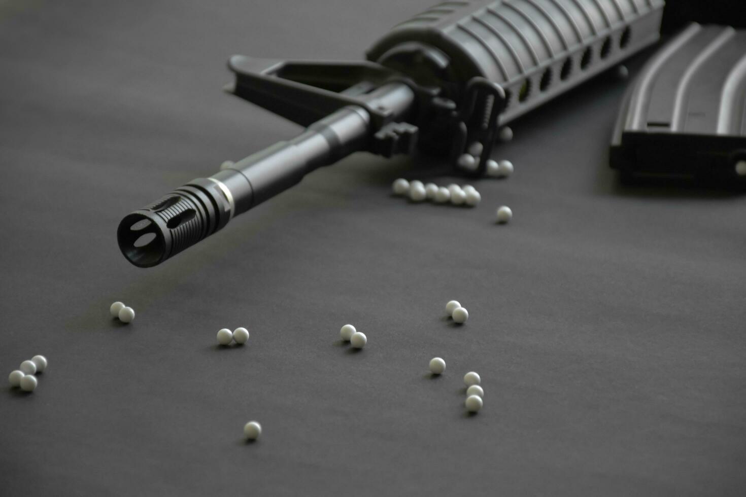 Closeup of white plastic bullets of airsoft gun or bb gun on wooden floor, soft and selective focus on white bullets. photo