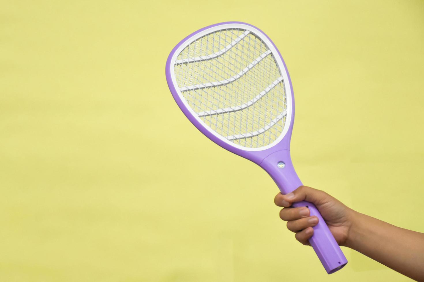 Electronic mosquito swatter in the office room for killing mosquitoes and insects inside the office, soft and selective focus. photo