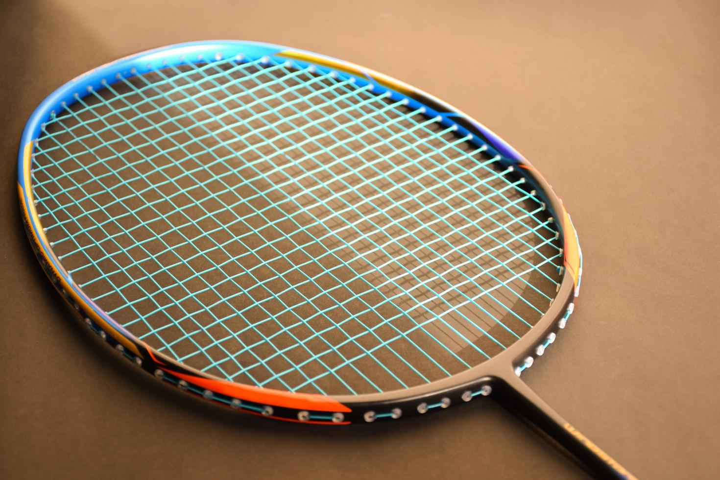 Badminton sports equipments, shuttlecocks, racket, grip, on floor of indoor badminton court. photo