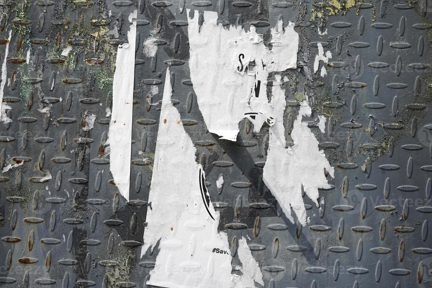 abstract torn paper poster on the wall for background texture. the rough pattern of the street art material. ruined placard poster for street design element. photo
