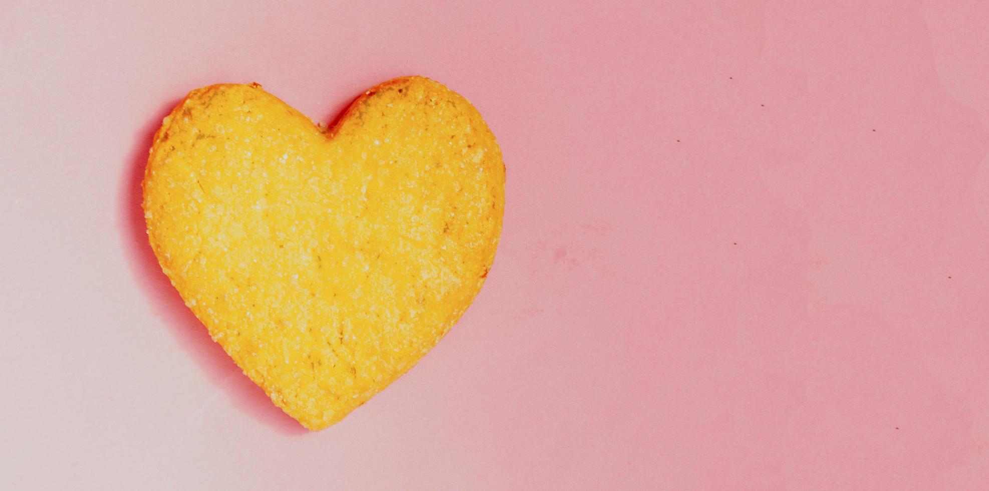 Valentine day.The cookie in shape heart on pink background.Top view,flatlay. photo