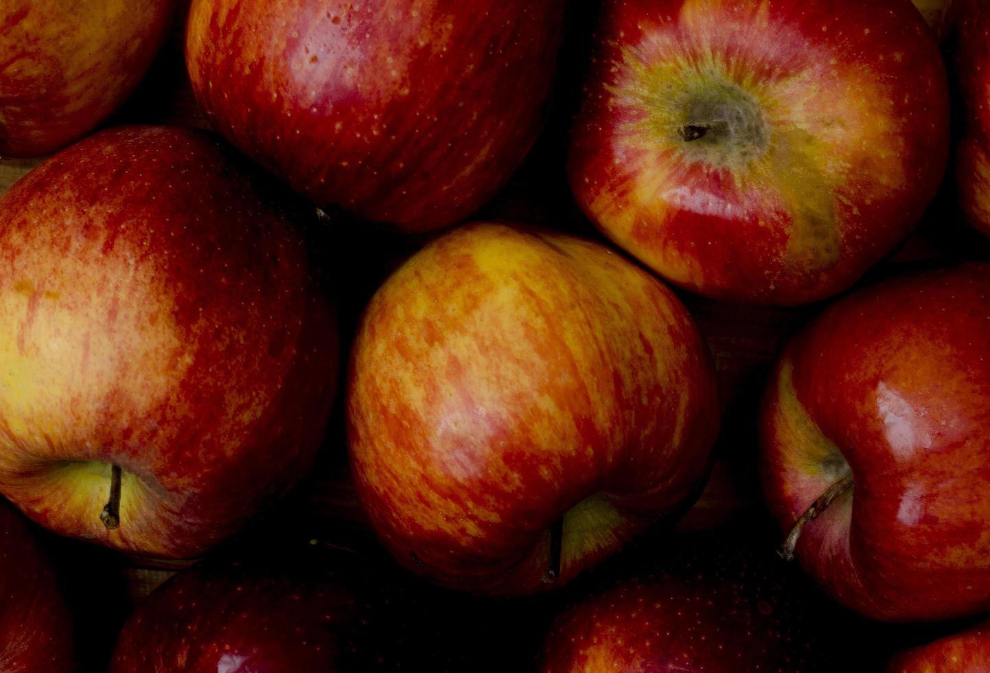 Apple background of slightly spoiled apples, close up. photo