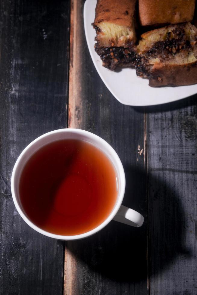 sweet cake and tea on wooden table photo