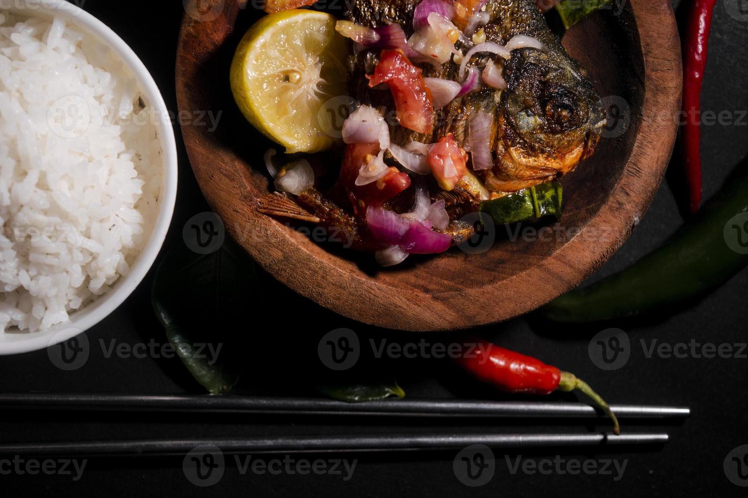 spicy fried fish menu with rice bowl on black background. Asian food photography. good for restaurant menu and poster photo