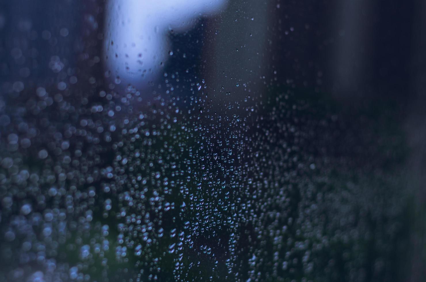 Blurred and focus of rain drop on glass window. photo