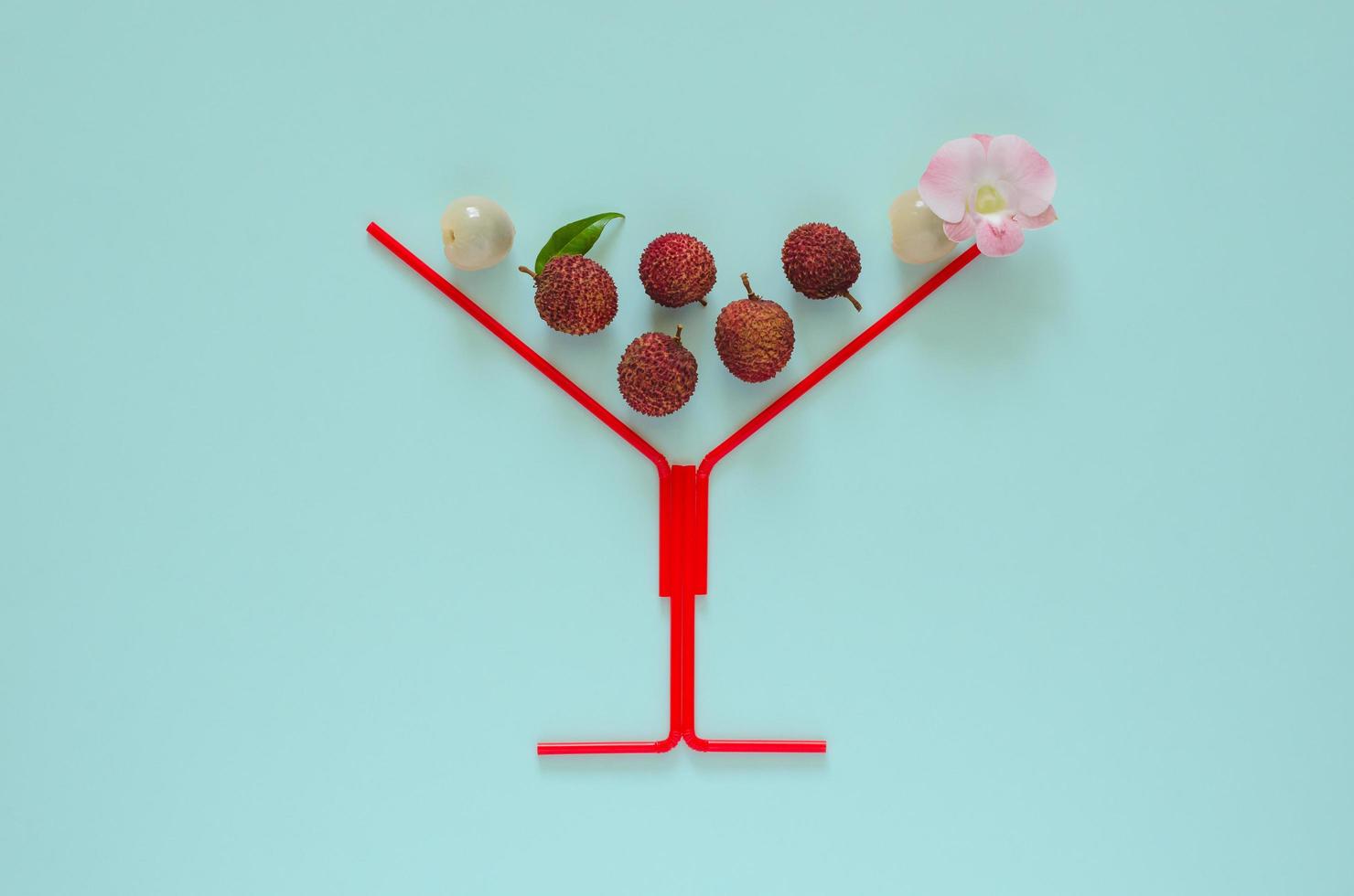 Fresh lychee fruits with stem and leaves, exotic asian fruits on pink background. photo