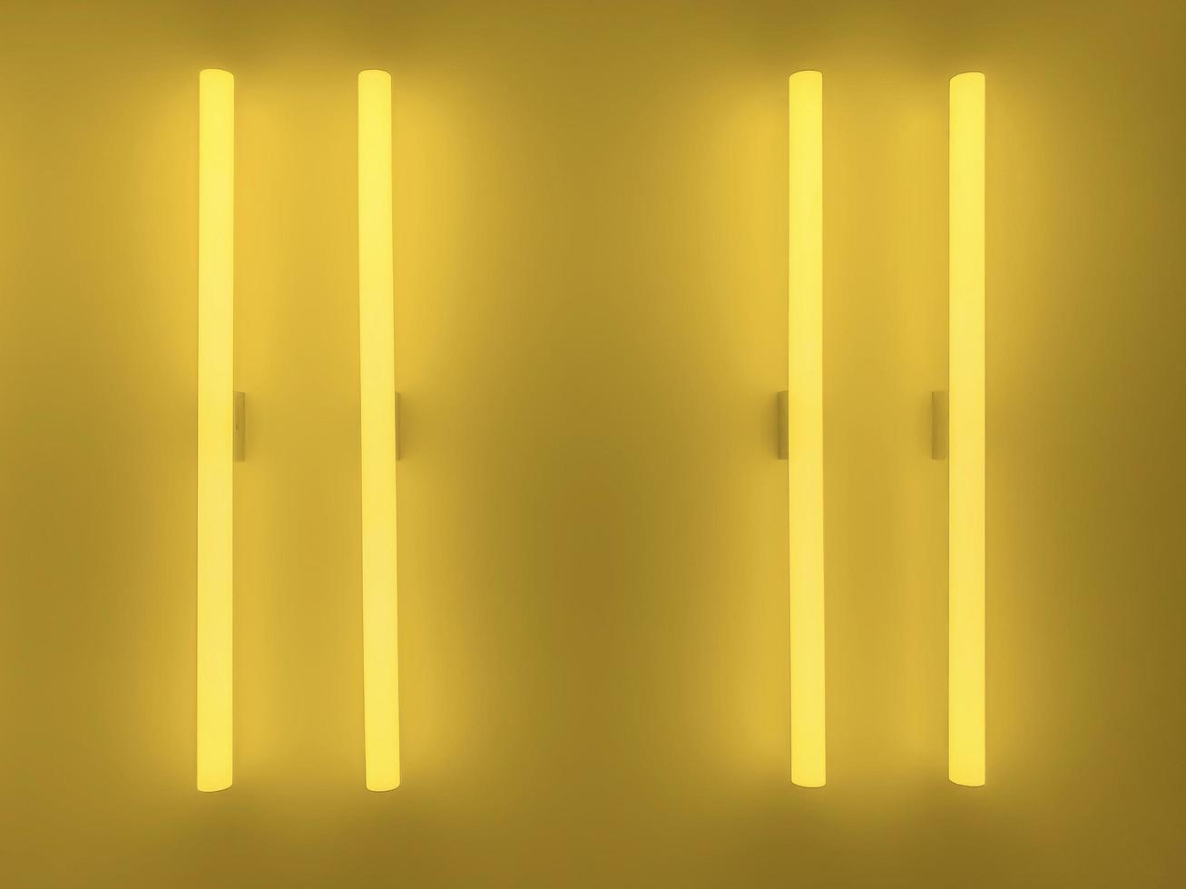 Two yellow fluorescent tubes on yellow wall. Background and textured concept. photo