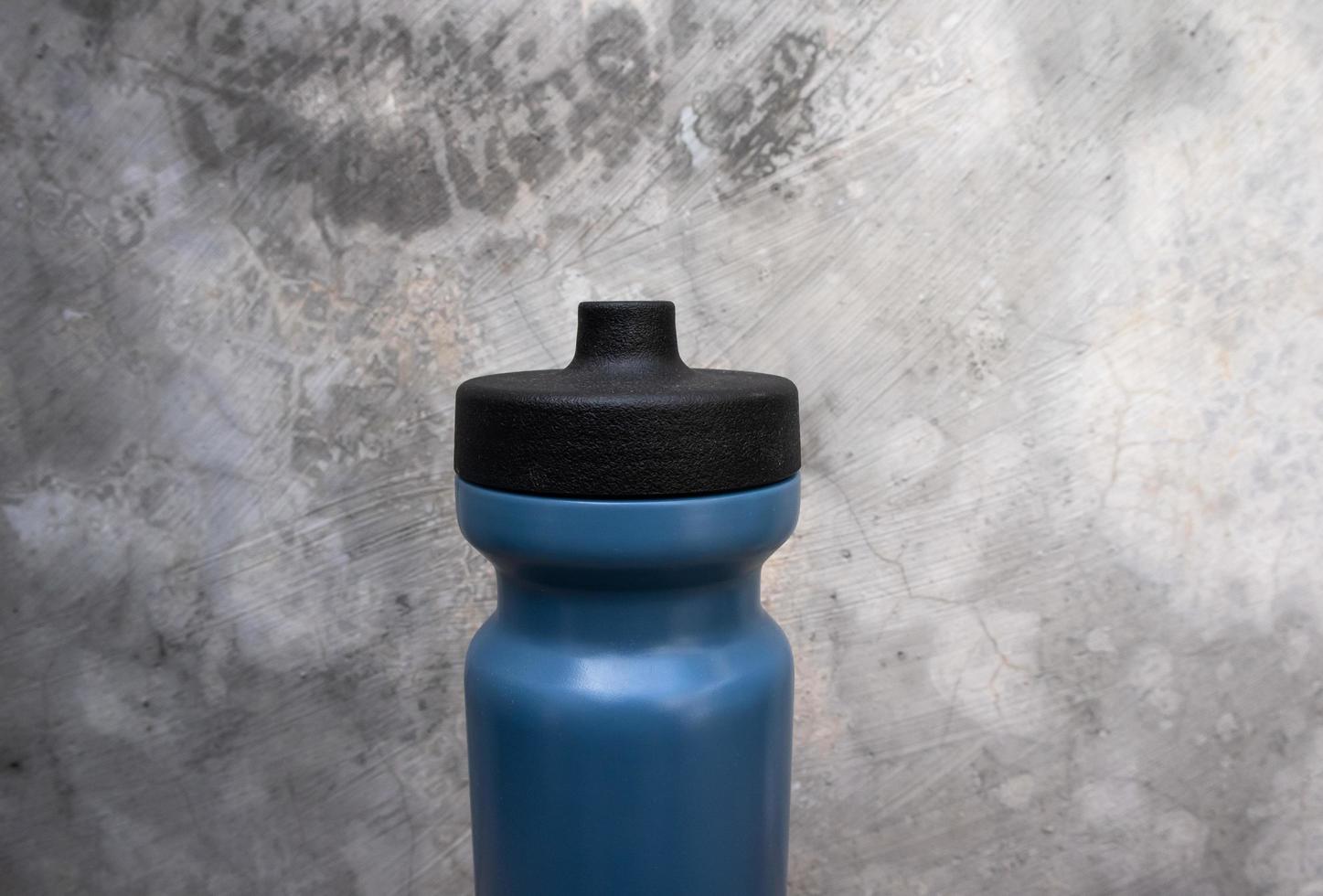 dark blue sport drinking water bottle with standing position photo