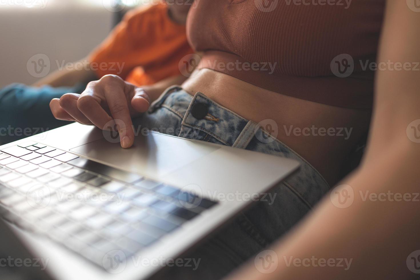 a woman with a child is sitting at a laptop photo