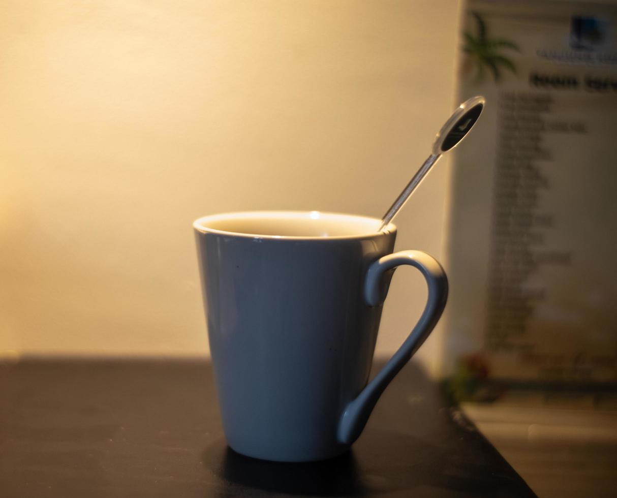 cup of coffee cup on table with low light silhouette photo