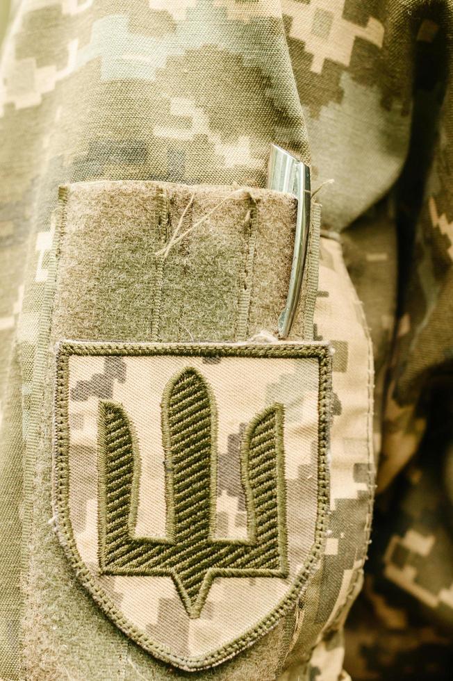 Chevrons on the Ukrainian military pixel uniform. Sleeve badge of the land forces of Ukraine. photo