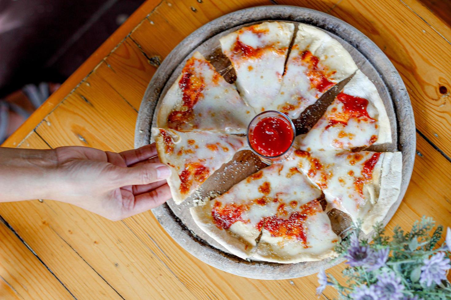 Soft light and Blurred image,Homemade pizza thin crust  pizza topping with seafood and cheese to the full range served on a round wooden tray to customers.copy space to insert text. photo