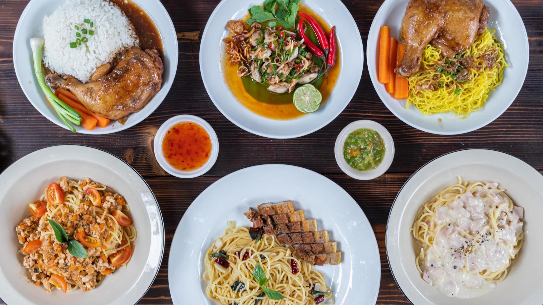 Many dishes are served on white plates and then prepared on wooden tables for friends and family members to enjoy at the party. Preparing lots of food to prepare for the party. photo