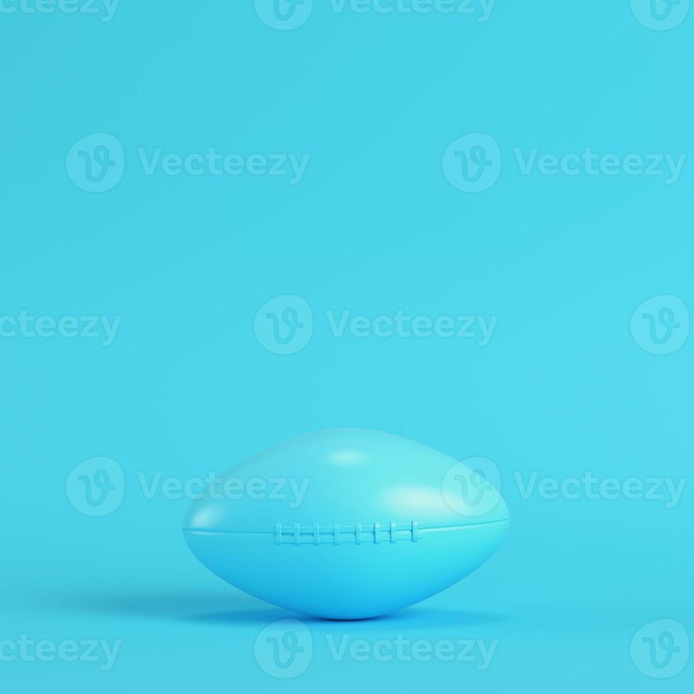 American football ball on bright blue background in pastel colors photo