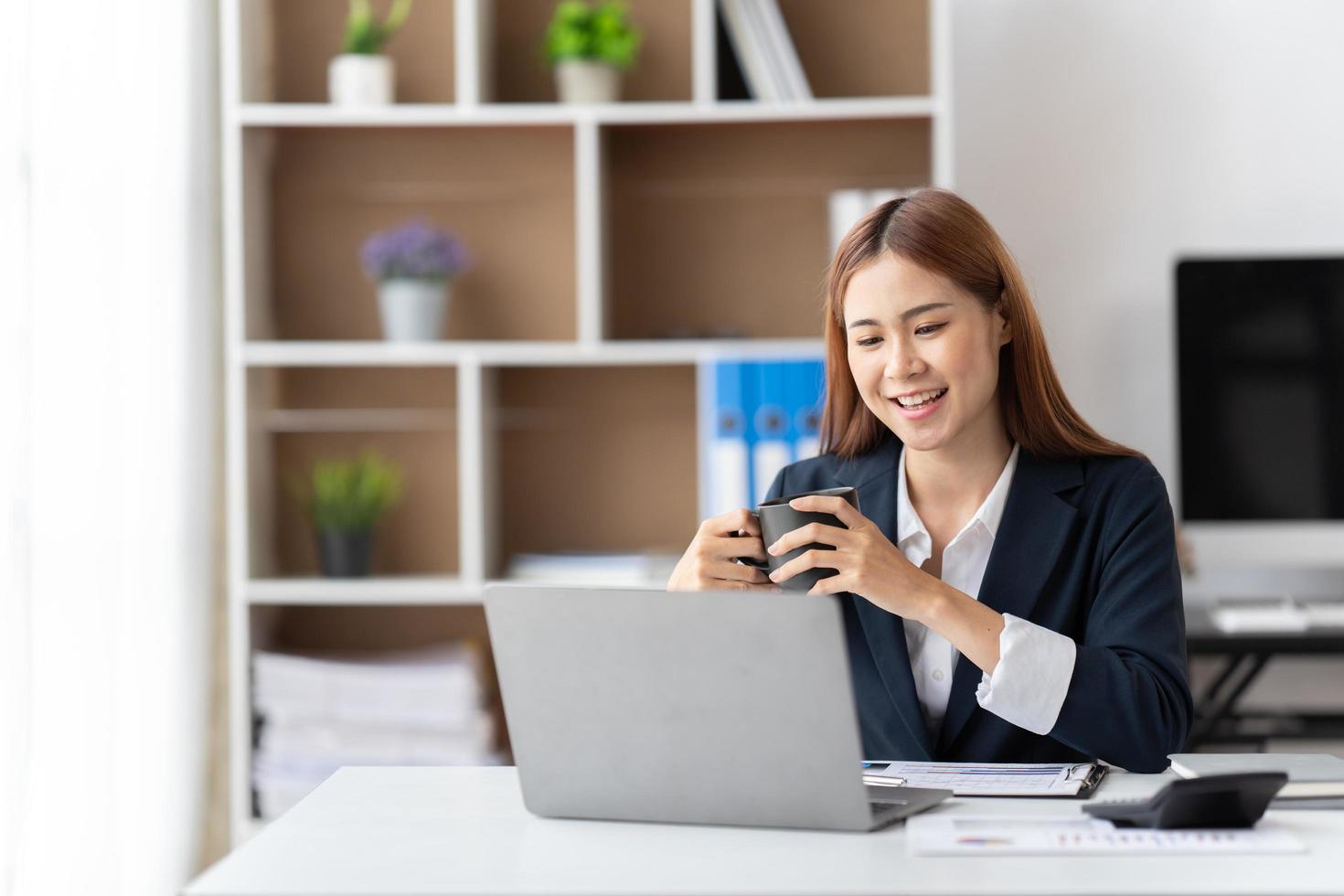 Portrait of smiling beautiful business asian woman working in office use computer with copy space. Business owner people sme freelance online marketing e-commerce telemarketing, work from home concept photo