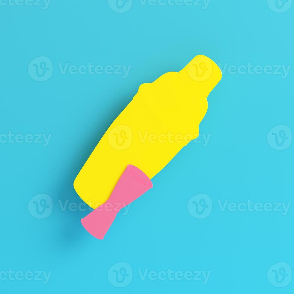 Yellow cocktail shaker with jigger on bright blue background in pastel colors photo