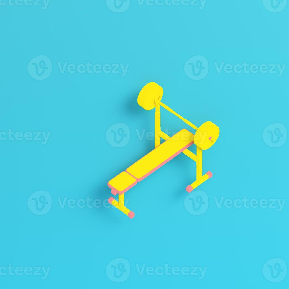 Yellow barbell with bench on bright blue background in pastel colors photo