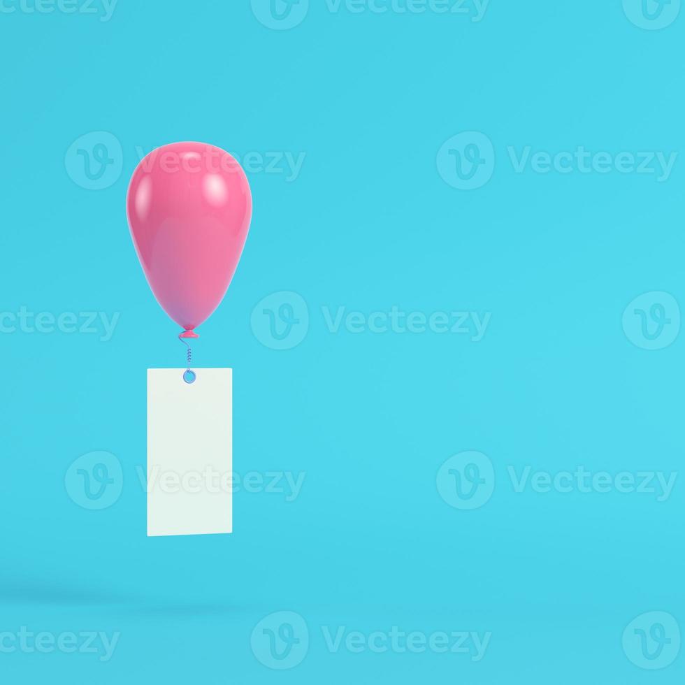 Pink air balloon with blank banner on bright blue background in pastel colors photo