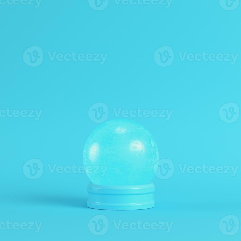 Pink crystal glass on bright blue background in pastel colors photo