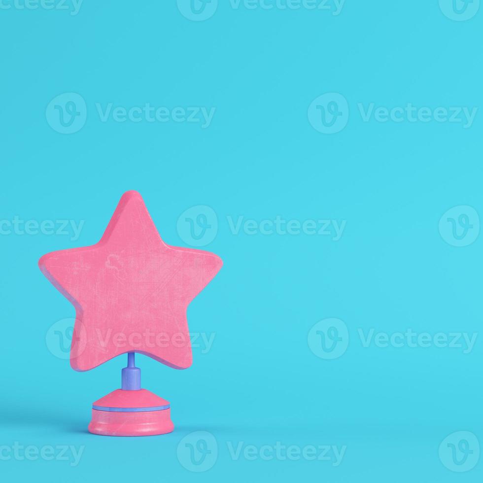 Star with stand on bright blue background in pastel colors. Minimalism concept photo