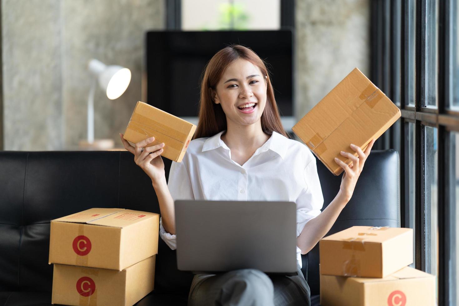 Starting small businesses SME owners female entrepreneurs check online orders to prepare to pack the boxes, sell to customers, sme business ideas online. photo