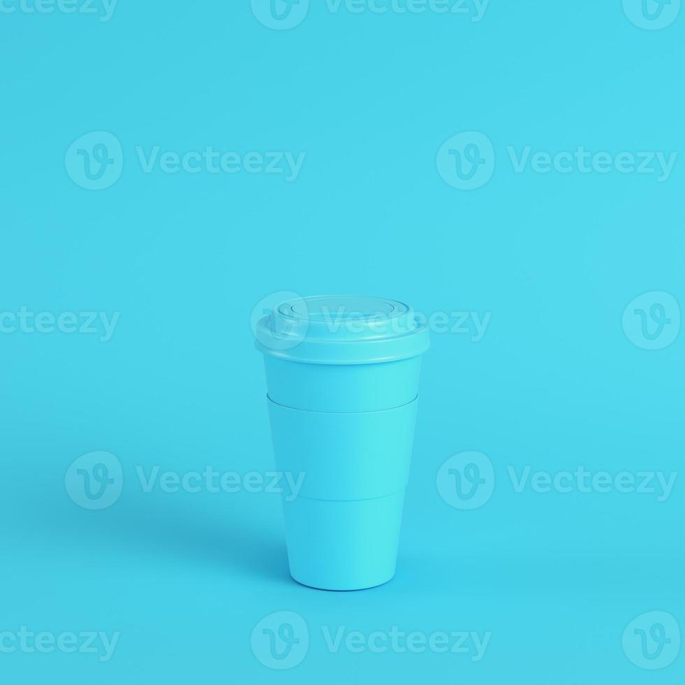 Coffee cup on bright blue background in pastel colors. Minimalism concept photo