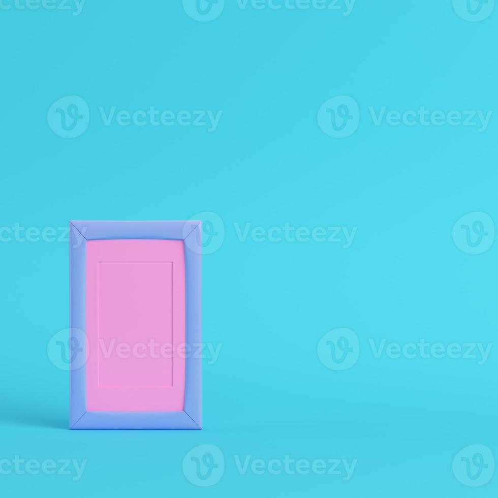 Pink blank frame on bright blue background in pastel colors photo