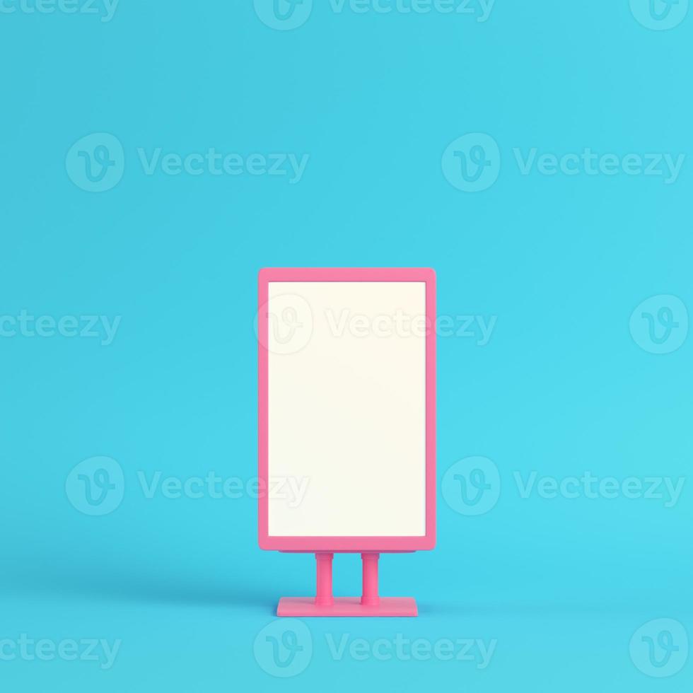 Pink blank advertising billboard on bright blue background in pastel colors photo