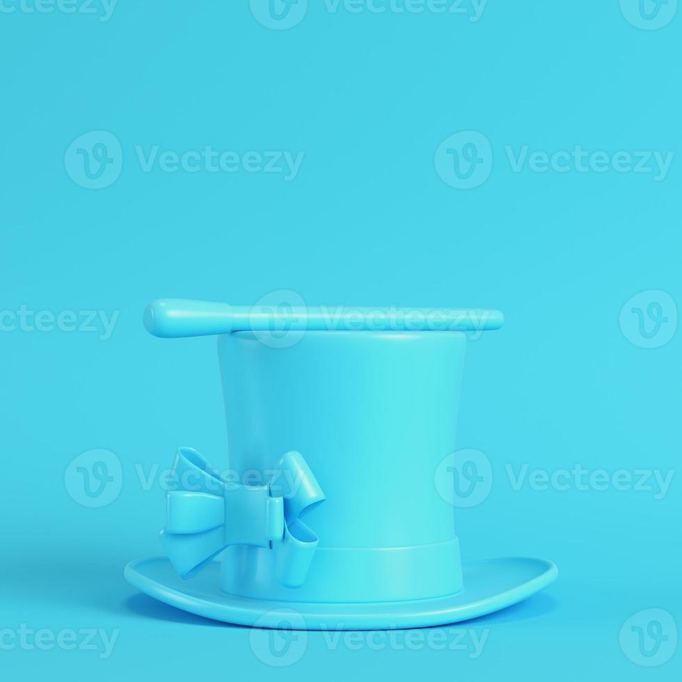 Top hat and magic wand on bright blue background in pastel colors photo