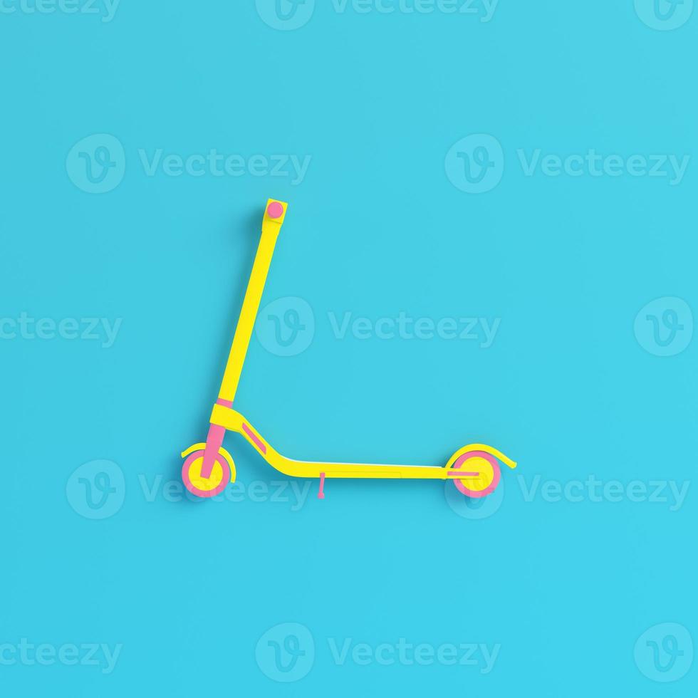 Yellow kick scooter on bright blue background in pastel colors. Minimalism concept photo