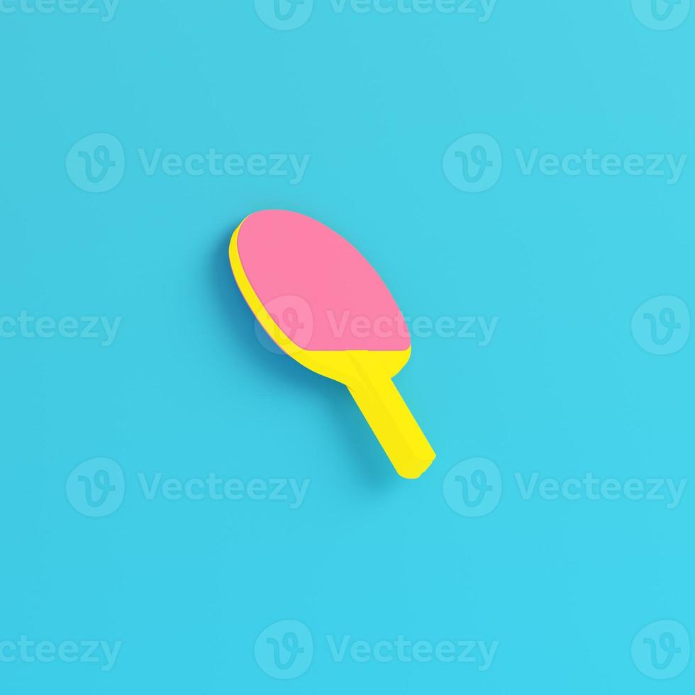Yellow ping pong racket on bright blue background in pastel colors. Minimalism concept photo