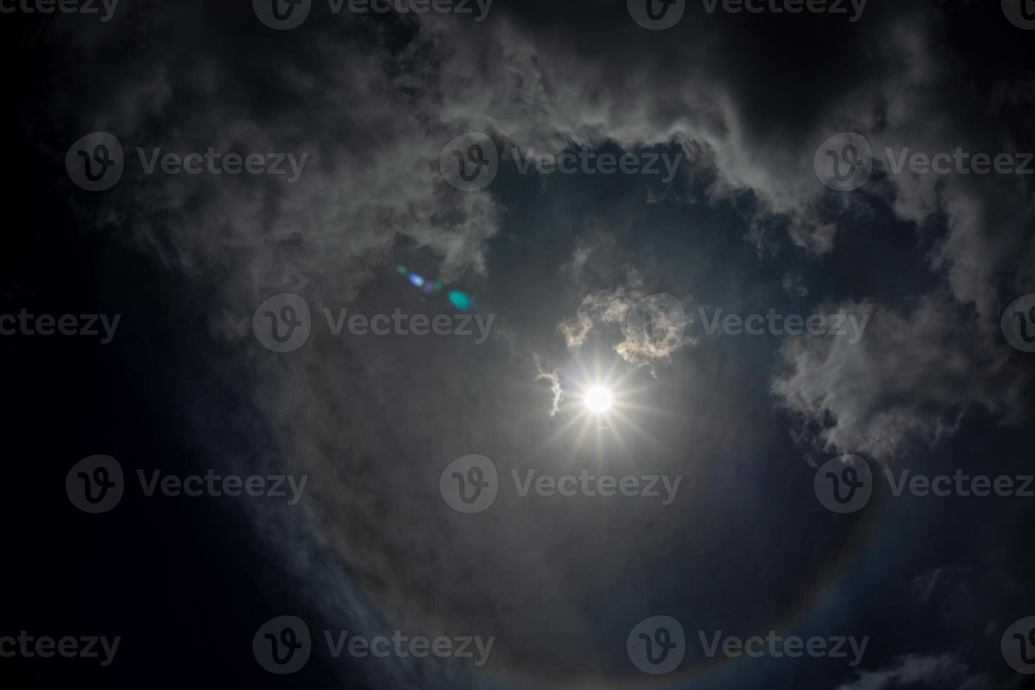 sun halo in the sky, dark background photo
