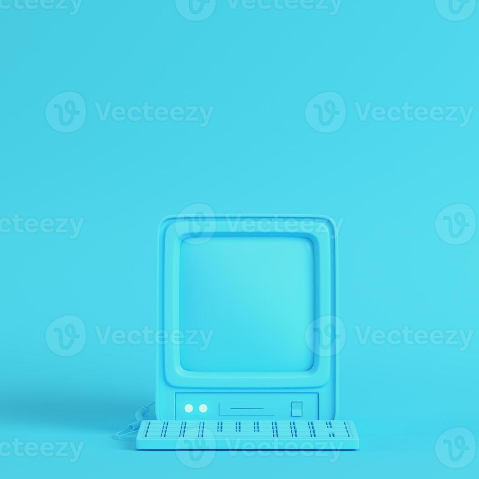 computadora retro sobre fondo azul brillante en colores pastel foto
