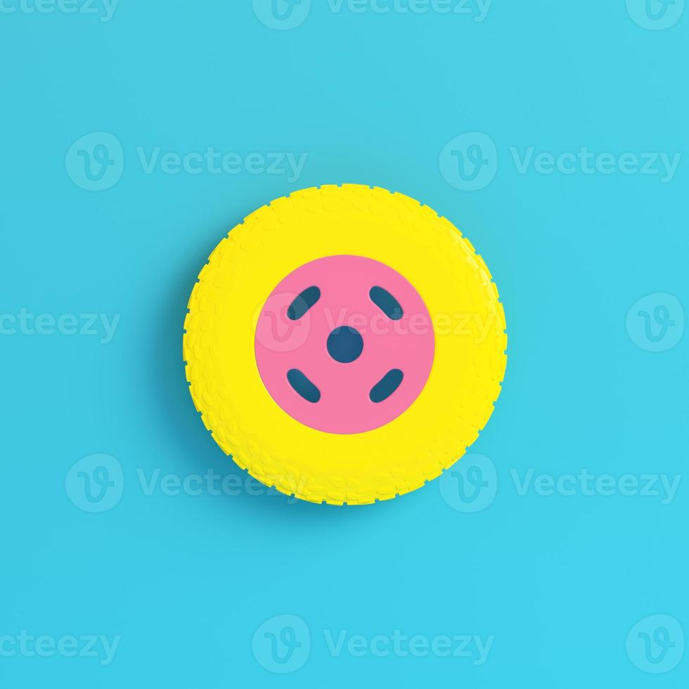 Yellow car wheel on bright blue background in pastel colors. Minimalism concept photo