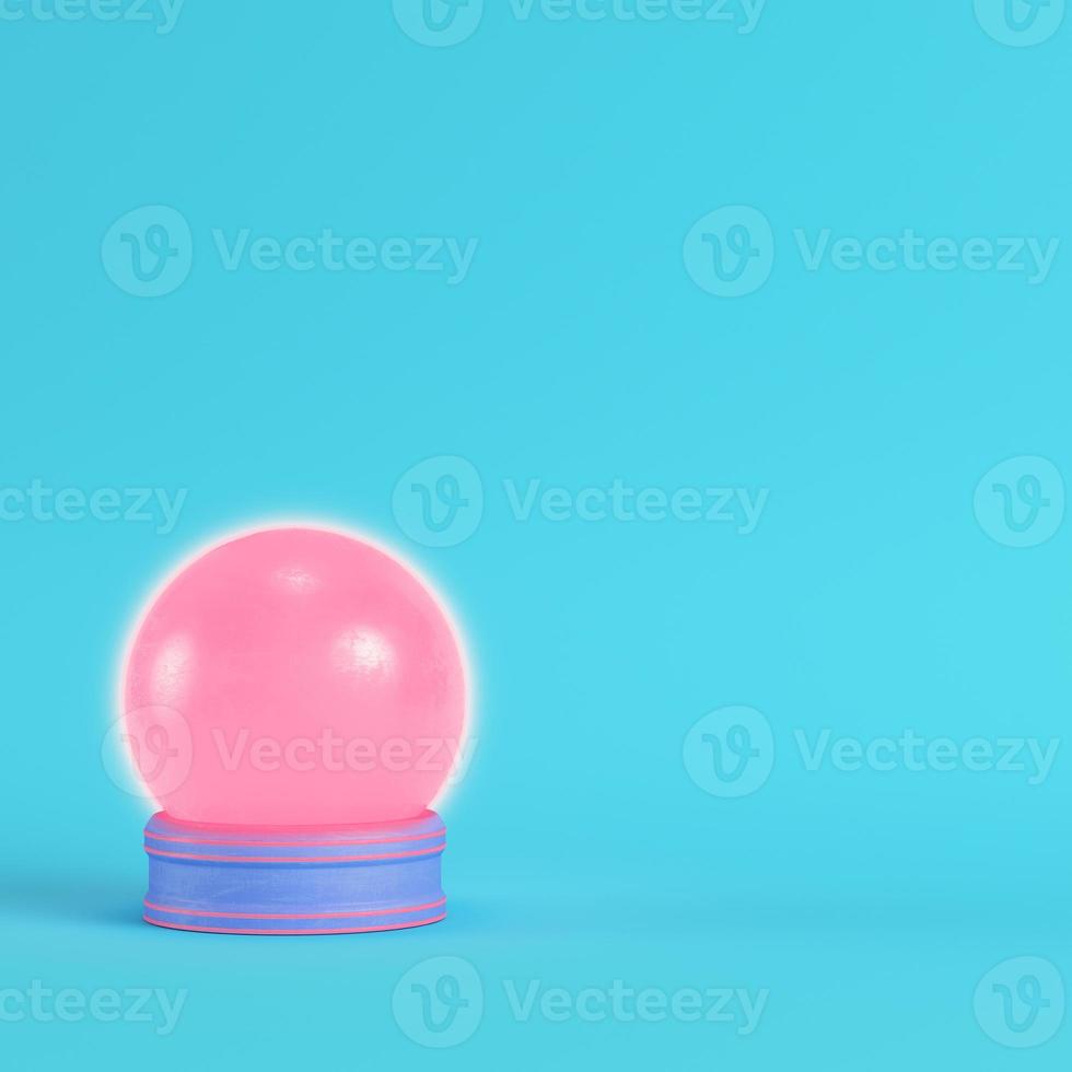 Pink crystal glass with paddles on bright blue background in pastel colors photo