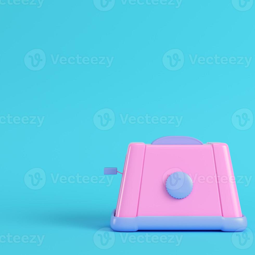 Pink toaster on bright blue background in pastel colors. Minimalism concept photo