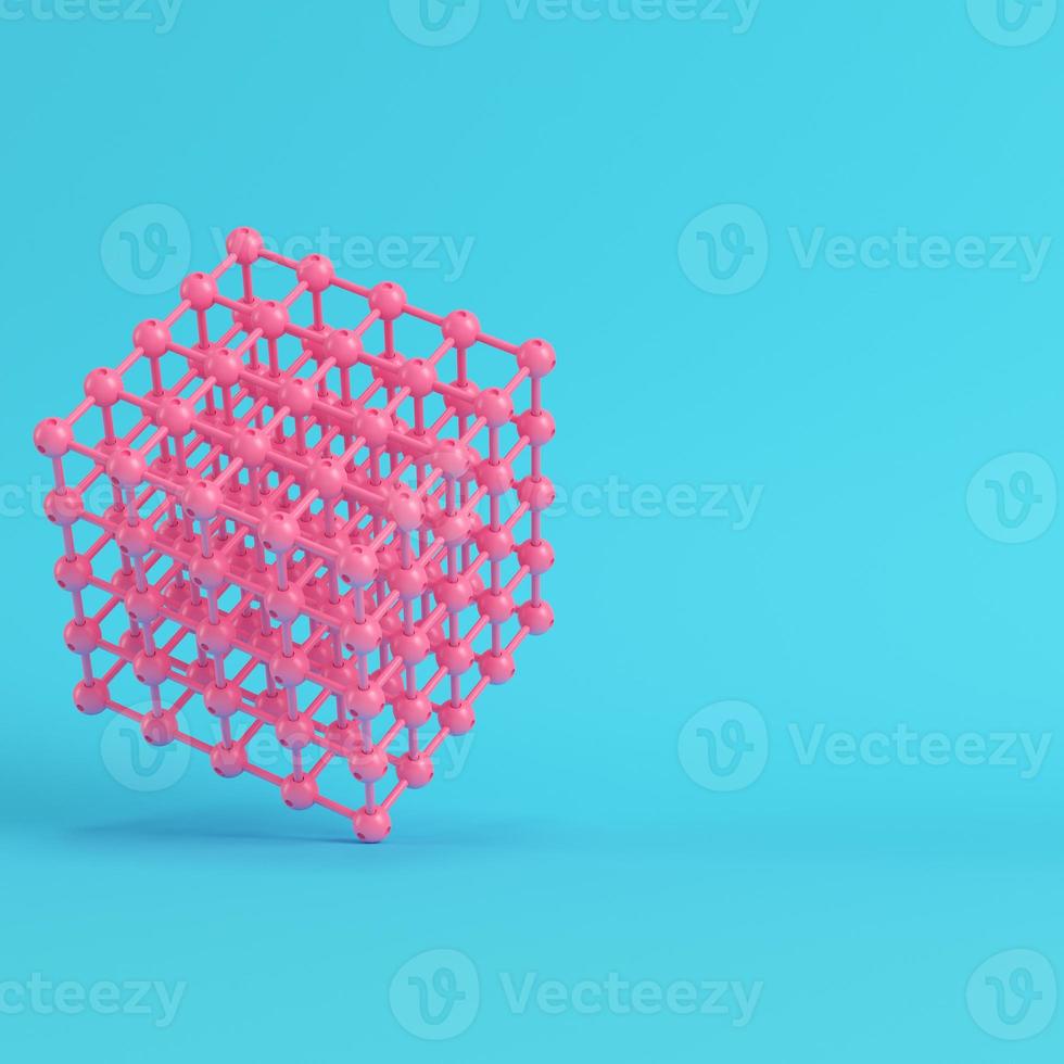 Abstract pink spheres in wire box on bright blue background in pastel colors photo