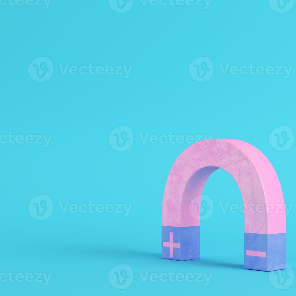 Pink magnet on bright blue background in pastel colors photo