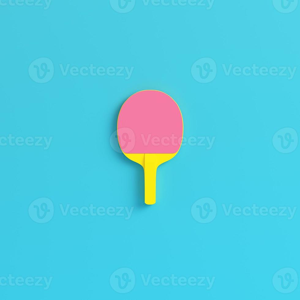 Yellow ping pong racket on bright blue background in pastel colors. Minimalism concept photo