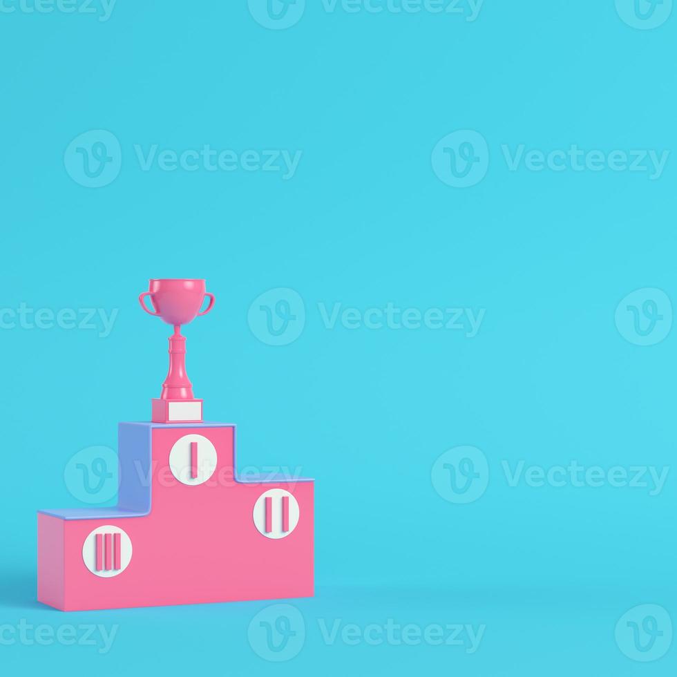 Pedestal with trophy cup on bright blue background in pastel colors. Minimalism concept photo