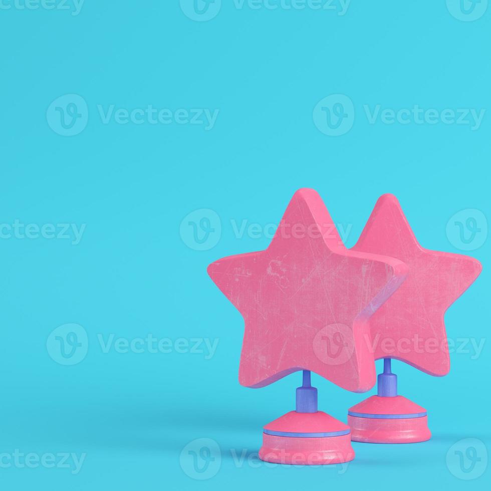 Stars with stand on bright blue background in pastel colors. Minimalism concept photo