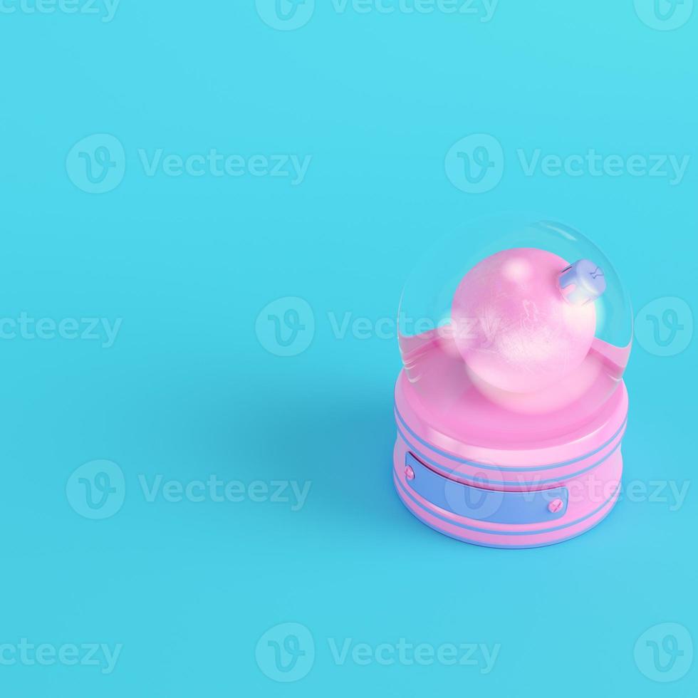 Pink snow globe with christmas bauble on bright blue background in pastel colors photo