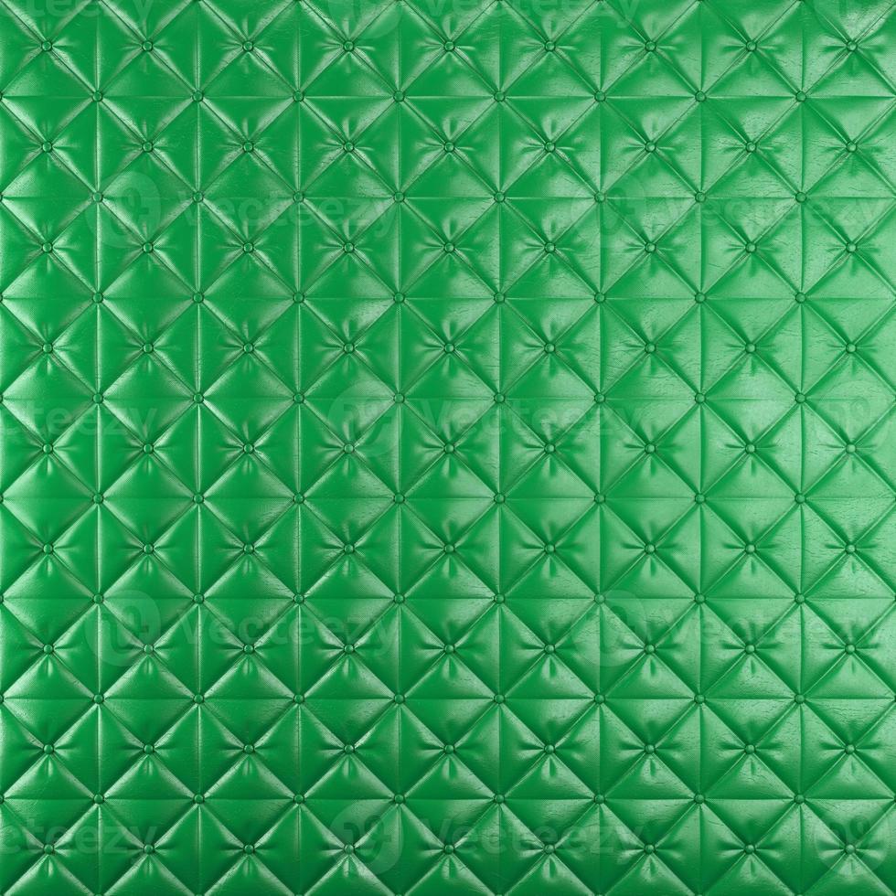 Stitched upholstery leather green background with buttons photo