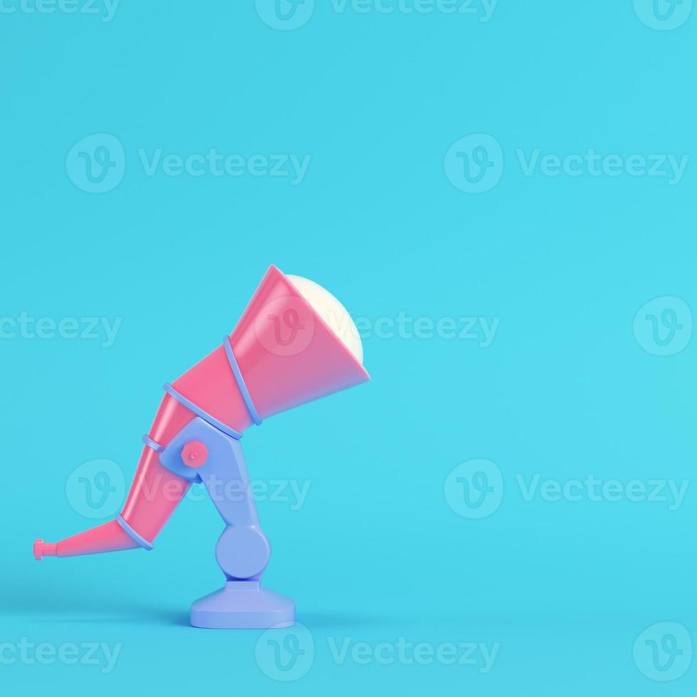 Pink telescope on bright blue background in pastel colors photo