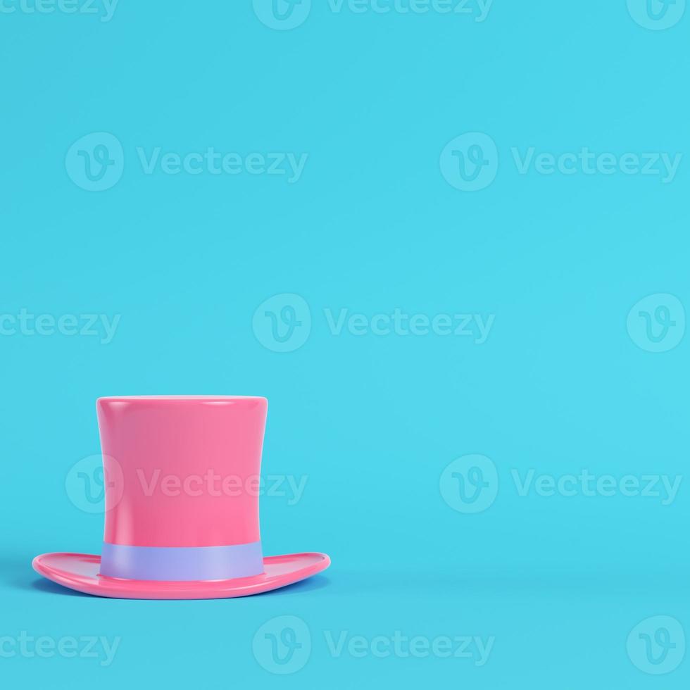 Pink top hat on bright blue background in pastel colors. Minimalism concept photo