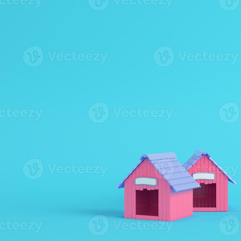 Pink doghouses on bright blue background in pastel colors photo