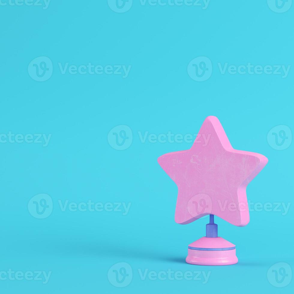 Star with stand on bright blue background in pastel colors. Minimalism concept photo