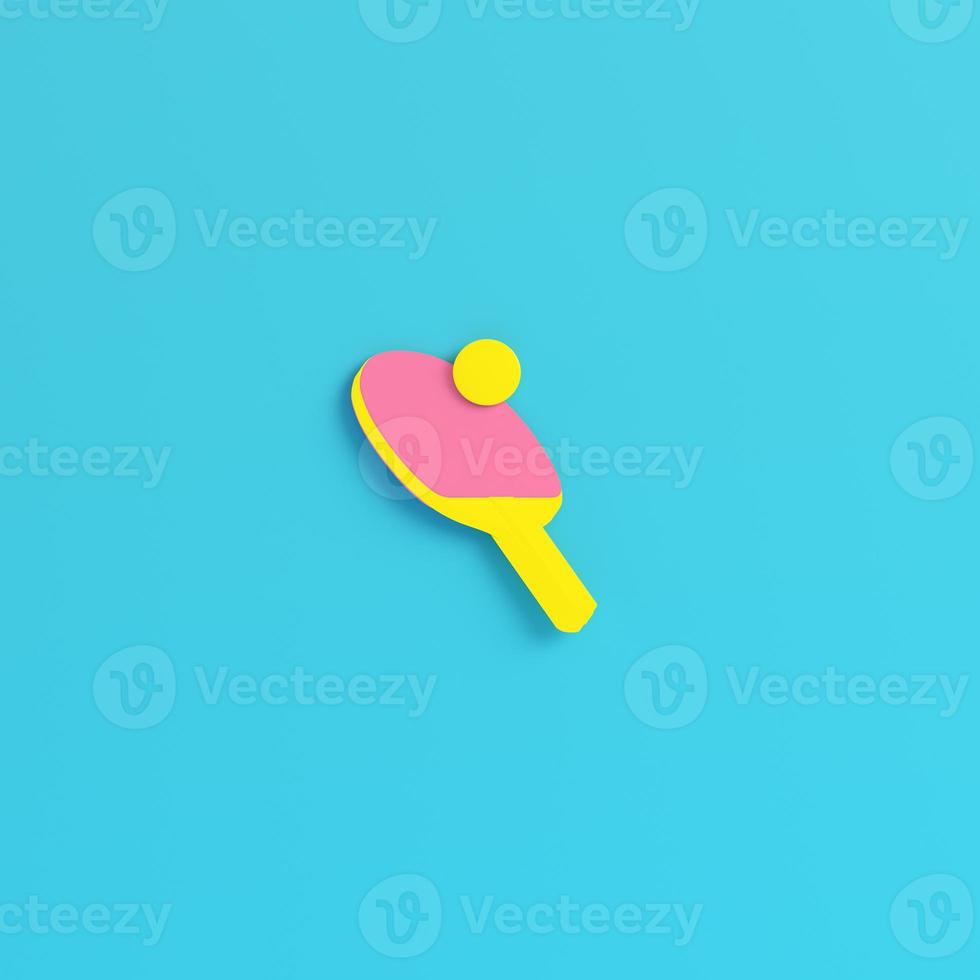 Yellow ping pong racket with ball on bright blue background in pastel colors. Minimalism concept photo