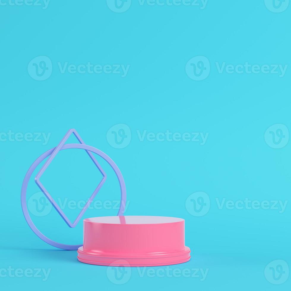 Pink pedestal with geometrical shapes on bright blue background in pastel colors photo