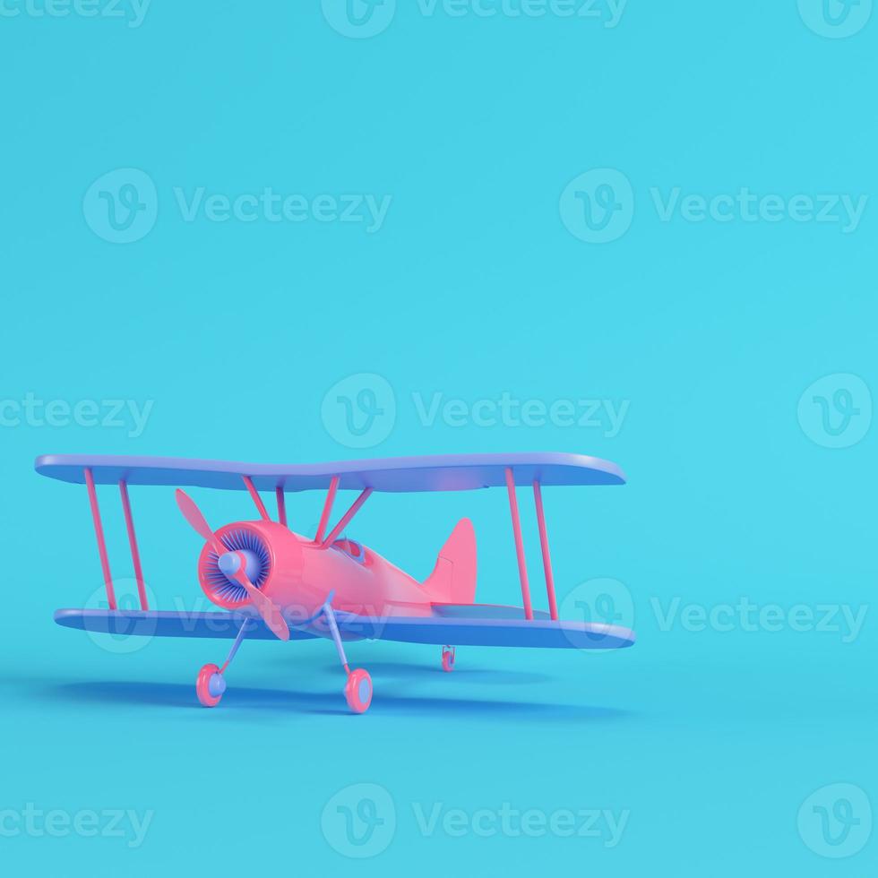 Pink biplane on bright blue background in pastel colors. Minimalism concept photo